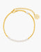 Gold anklet with pearl accents on a white background