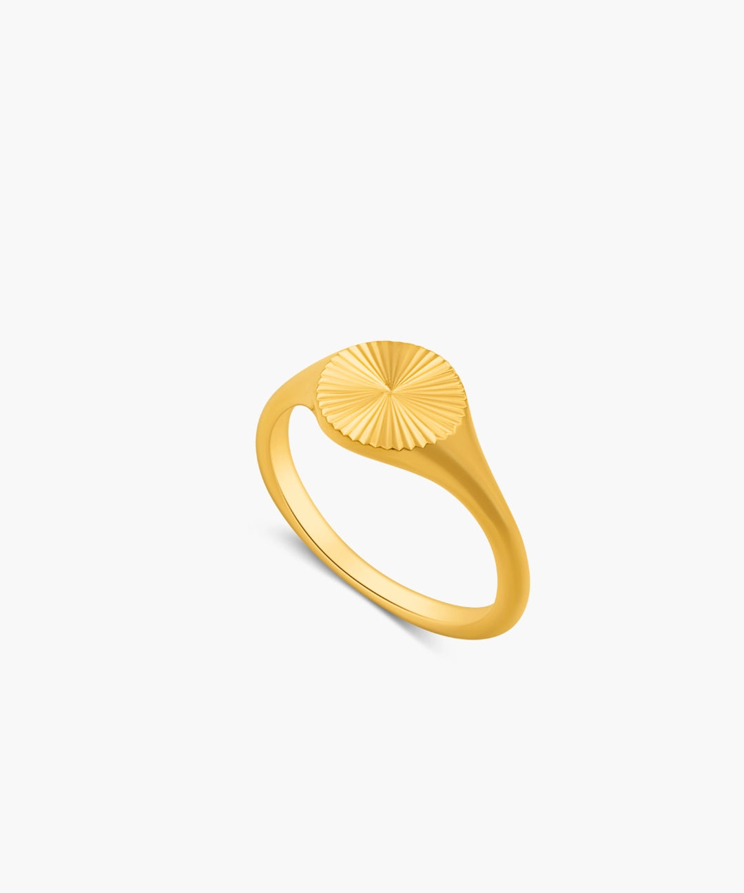 Gold ring with a sunburst design on a white background