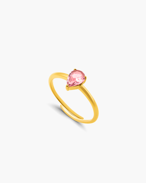 Gold ring with a pink gemstone on a white background
