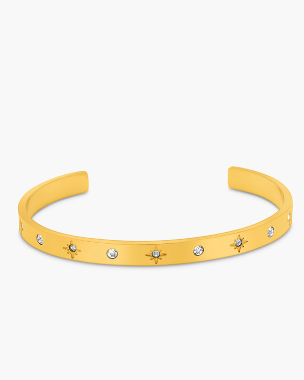 Yellow bracelet with star and gemstone details on a white background