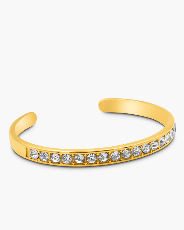 Gold bracelet with crystal stones on a white background