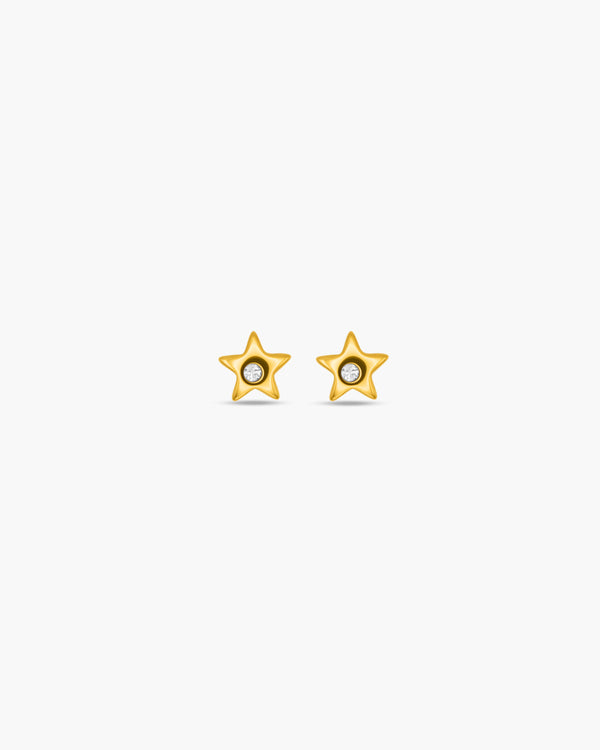 Gold star-shaped earrings on a white background