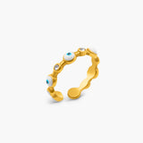 Gold ring with embedded stones on a white background