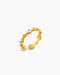 Gold ring with embedded stones on a white background