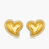 Gold heart-shaped earrings with embedded stones on a white background