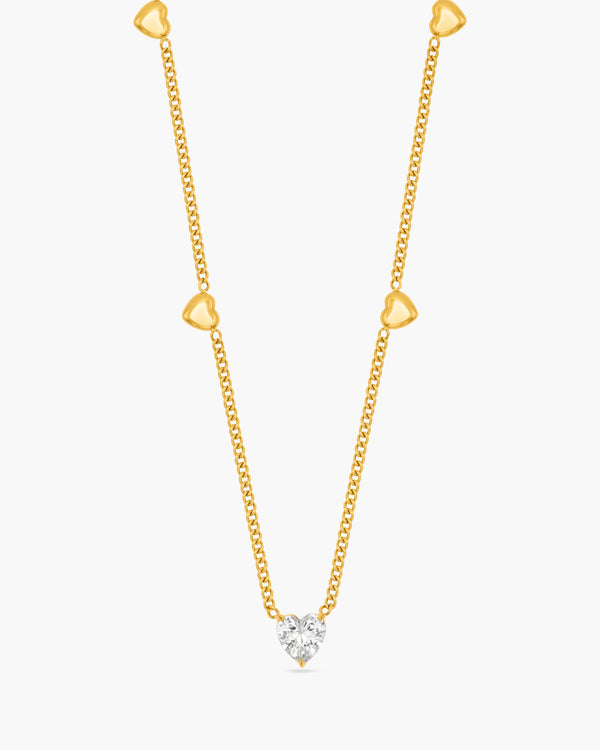 Gold necklace with a diamond pendant on a white background