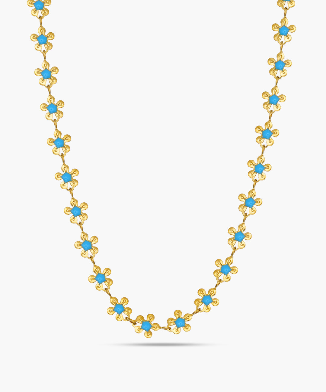 Gold necklace with blue stones on a white background