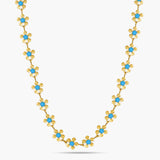 Gold necklace with blue stones on a white background