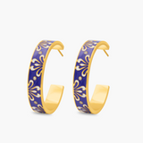 Pair of purple hoop earrings with gold accents on a white background