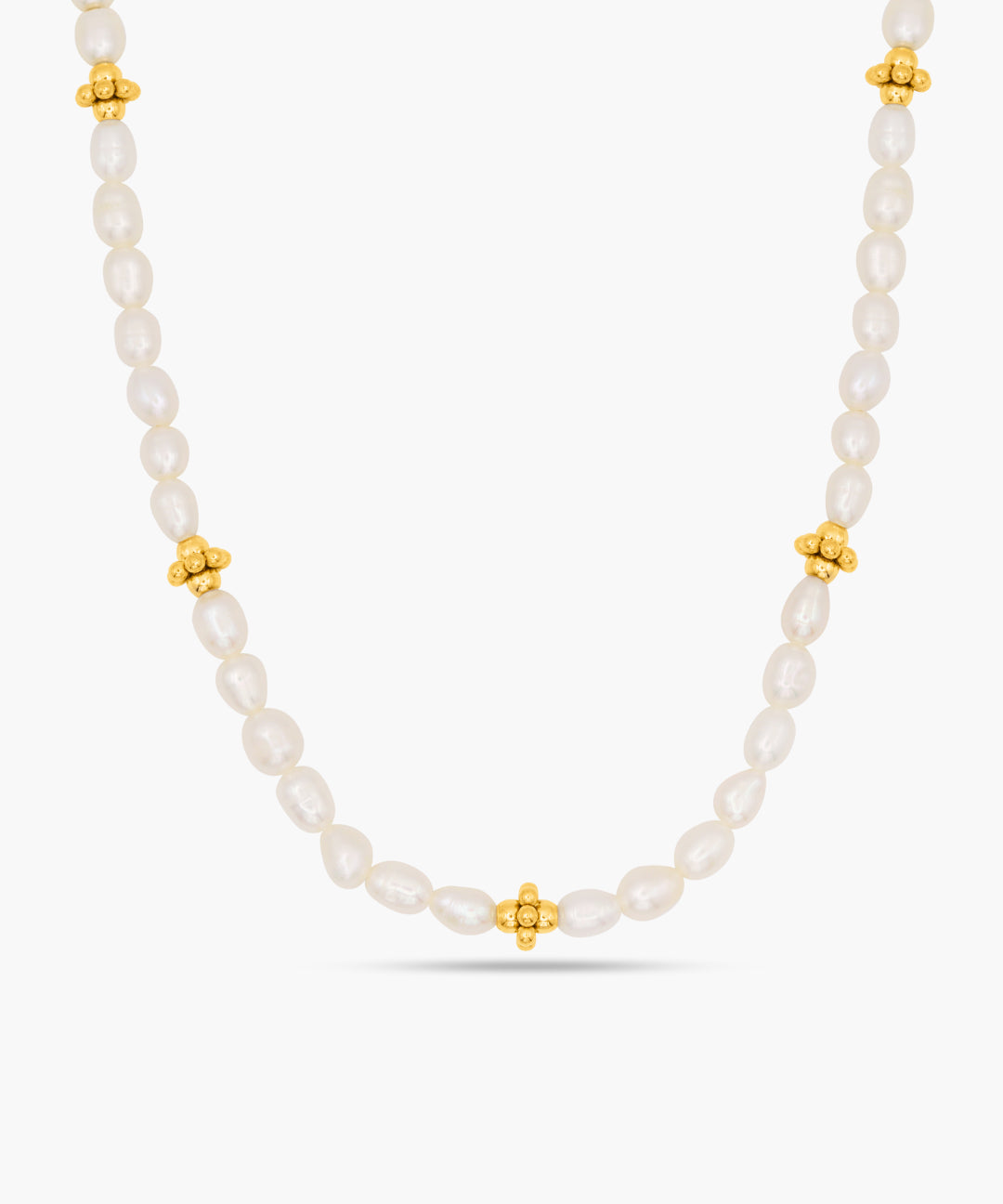 Pearl necklace with gold beads on a white background