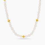 Pearl necklace with gold beads on a white background