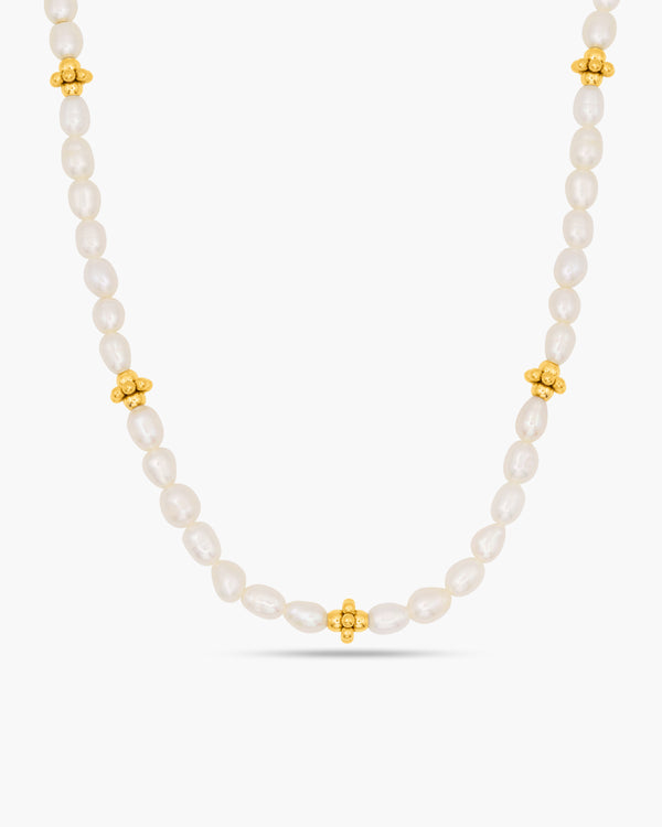 Pearl necklace with gold beads on a white background