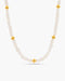 Pearl necklace with gold beads on a white background