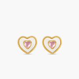 Heart-shaped earrings with pink gemstones on a white background