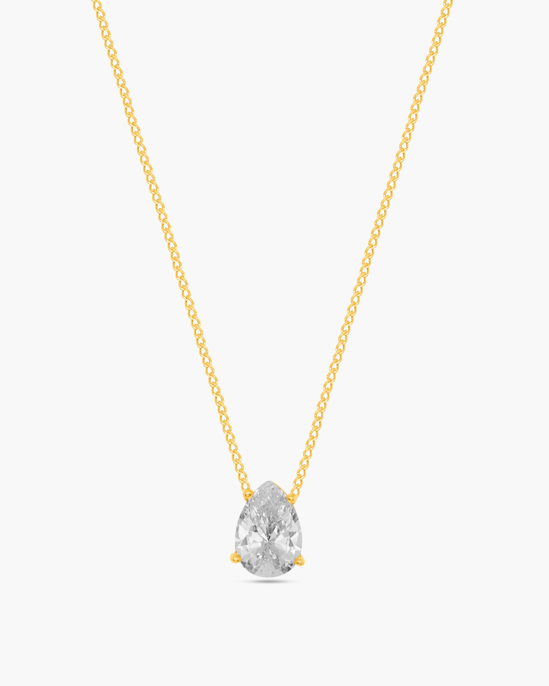 Gold necklace with a clear teardrop-shaped pendant on a white background
