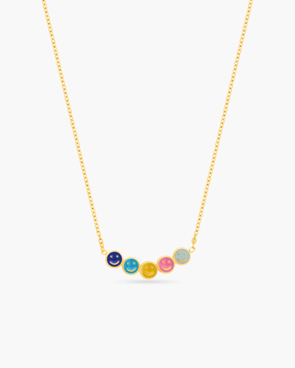 Necklace with colorful round pendants on a gold chain against a white background