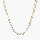 Gold necklace with clear stones on a white background