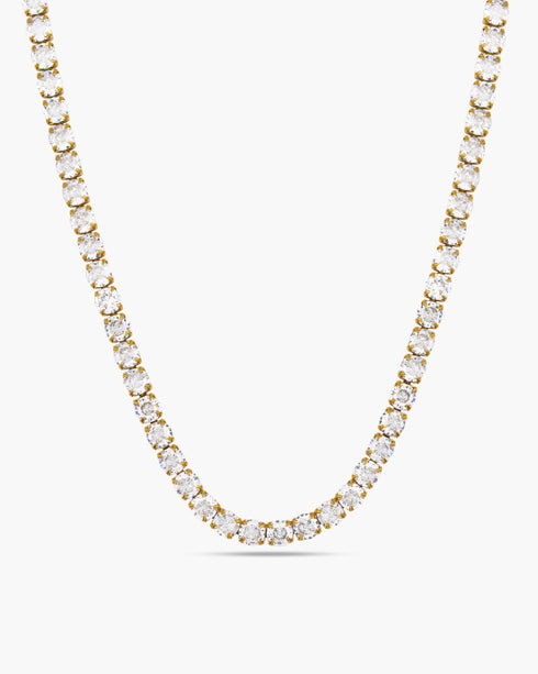 Gold necklace with clear stones on a white background