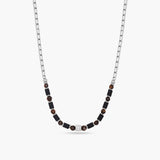 Necklace with black beads on a white background