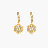 Gold earrings with diamond-like stones on a white background