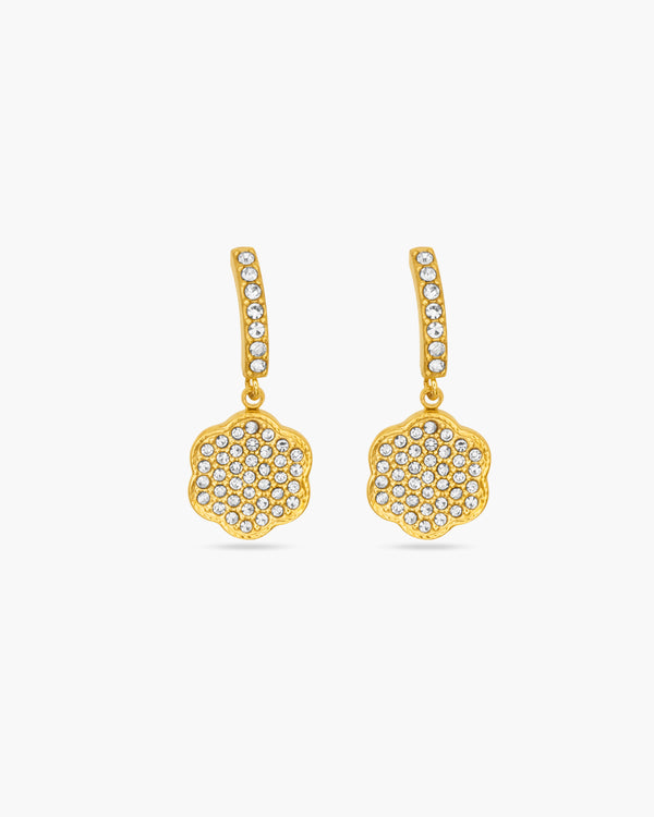 Gold earrings with diamond-like stones on a white background