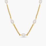 Gold chain necklace with white pearls on a white background
