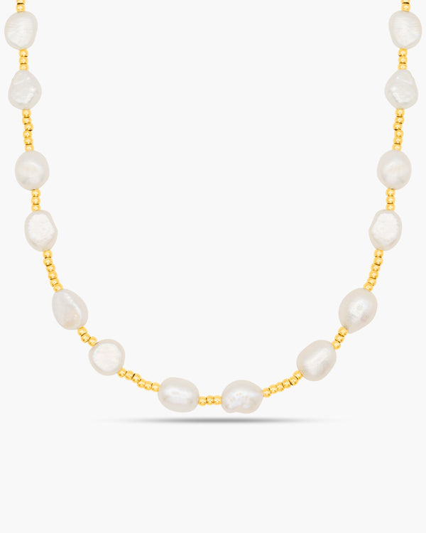 Pearl necklace with gold chain on a white background