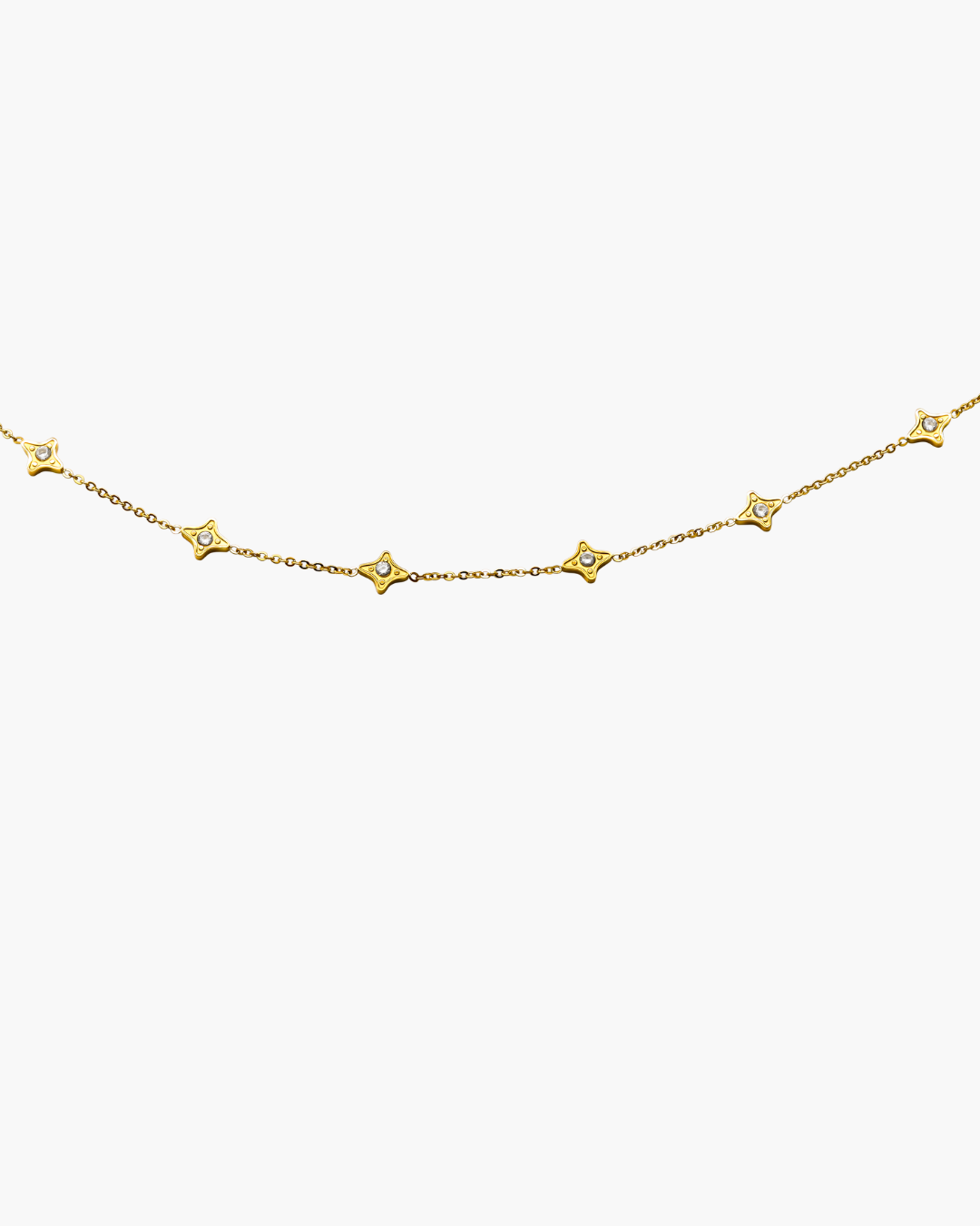 Gold necklace with star-shaped pendants on a white background