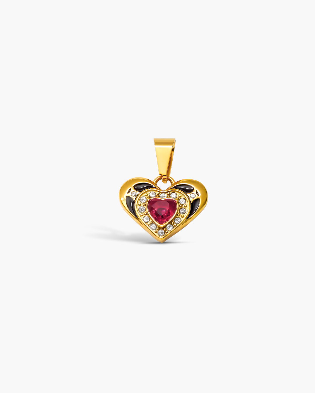 Heart-shaped gold pendant with a red gemstone on a white background