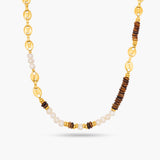 Necklace with gold, brown, and white beads on a white background