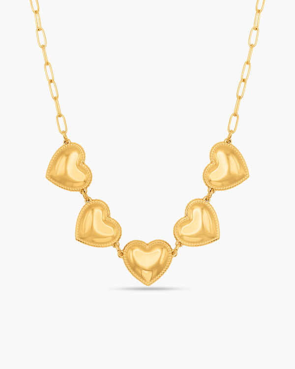 Gold heart-shaped necklace on a white background