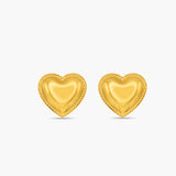 Gold heart-shaped earrings on a white background